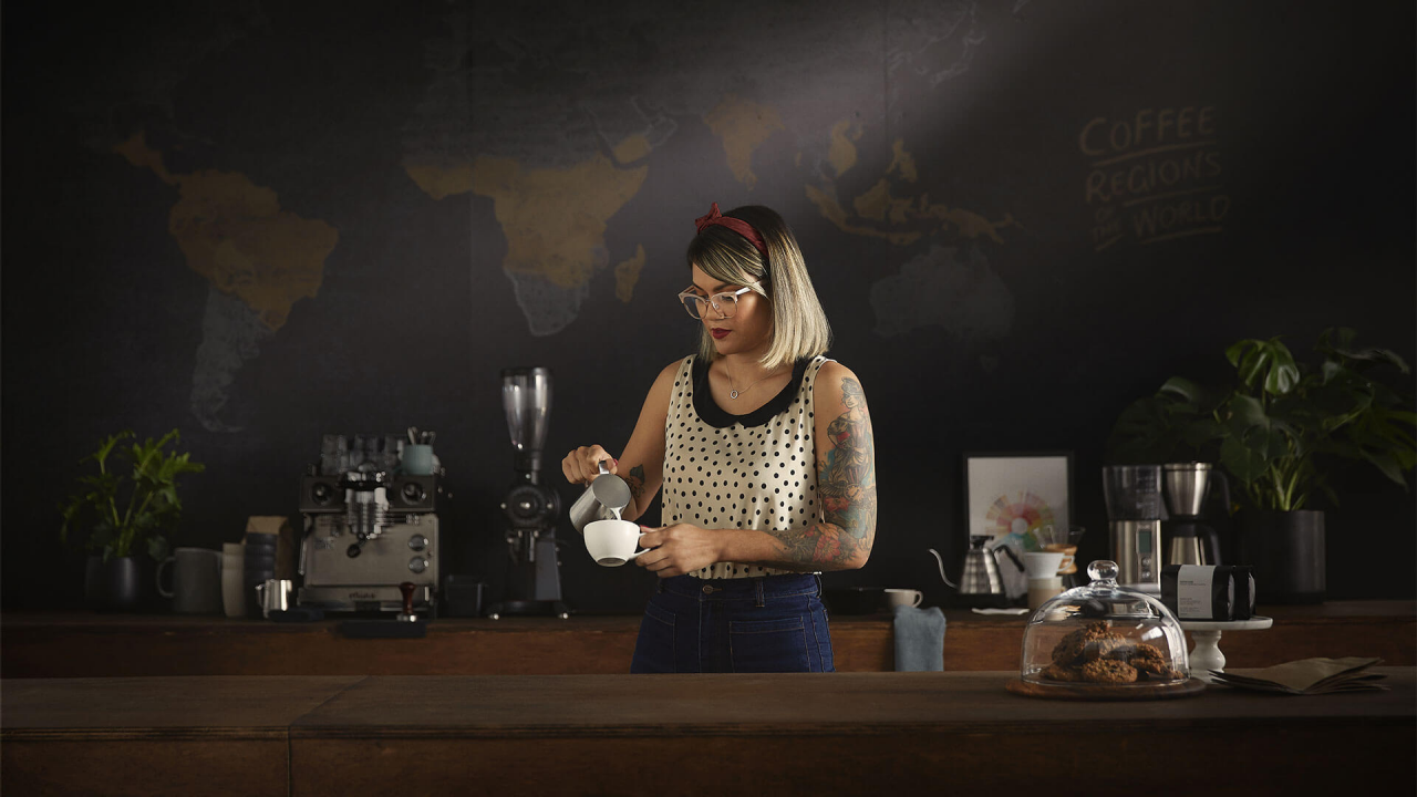 A barista making a cappuccino.